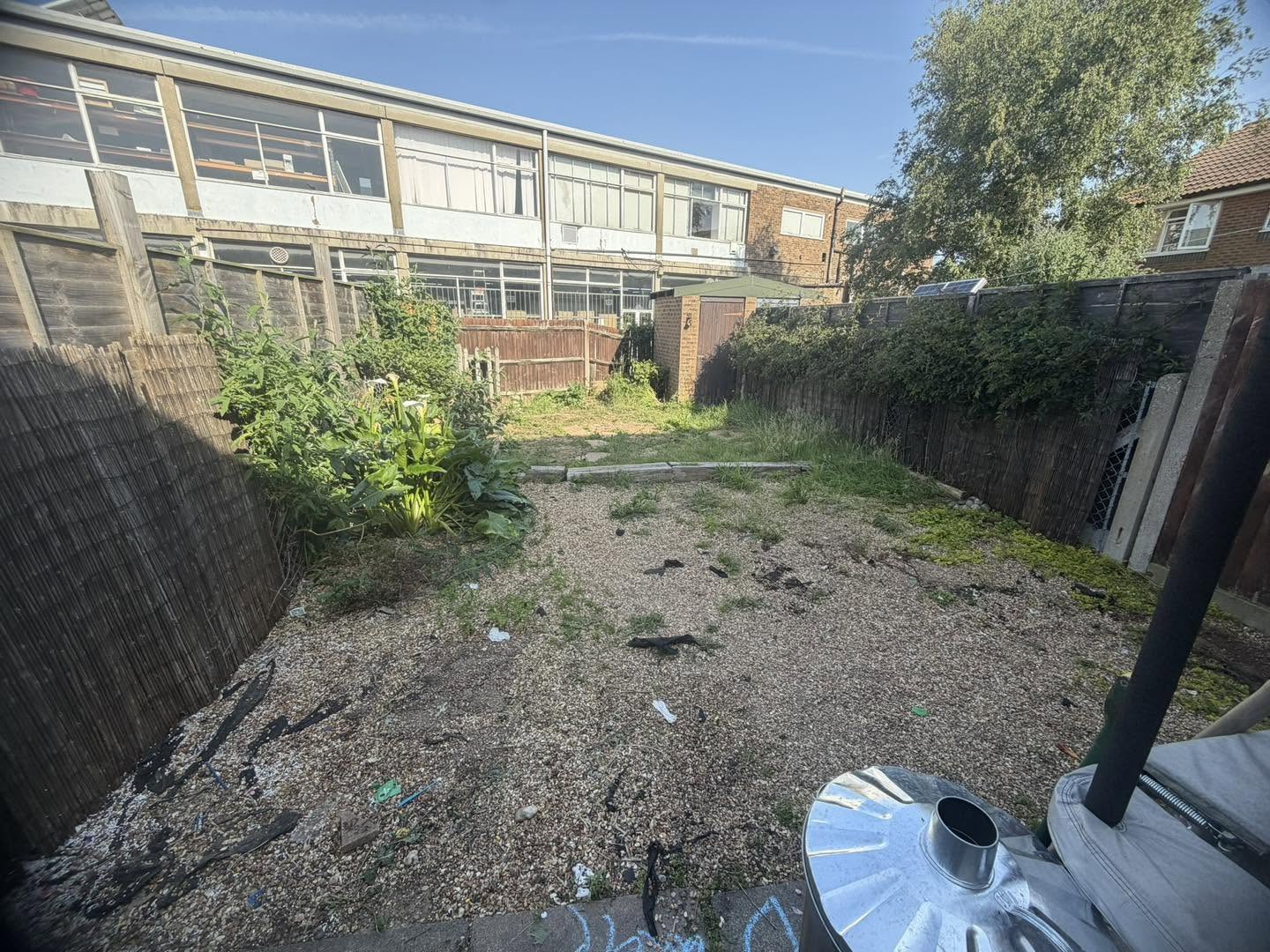 Before: a narrow back garden of bare gravel and weeds