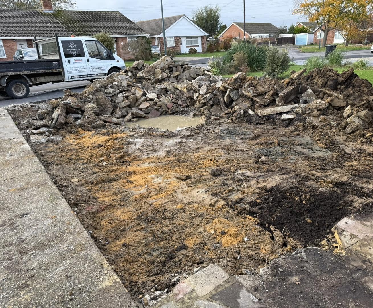 The DS Driveways & Patios tipper van beside a driveway being dug out