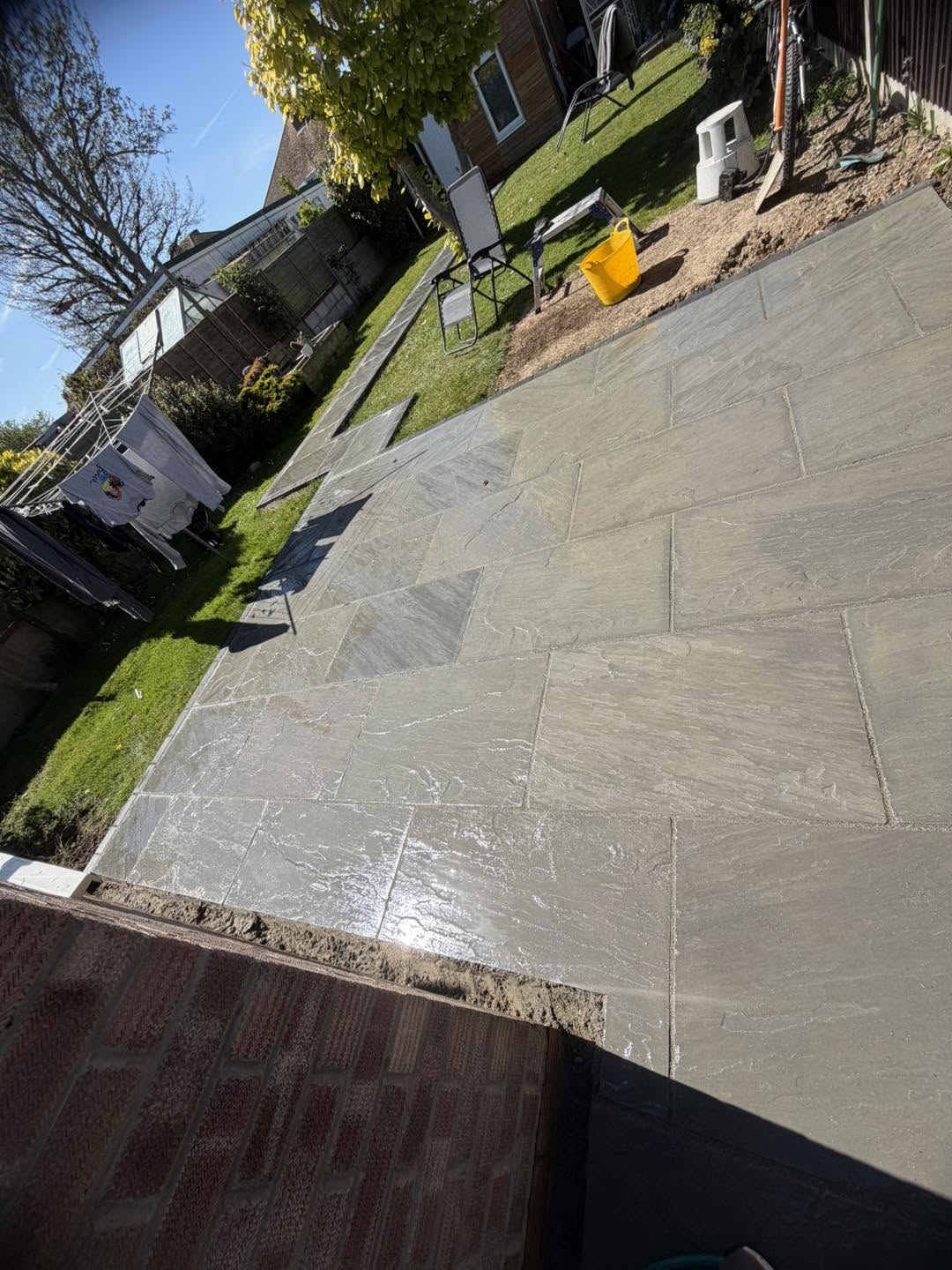 The grey patio seen from the side of the house