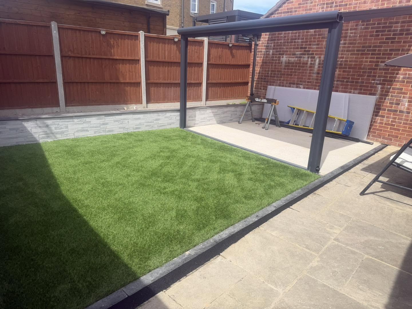The finished lawn and patio in a walled garden