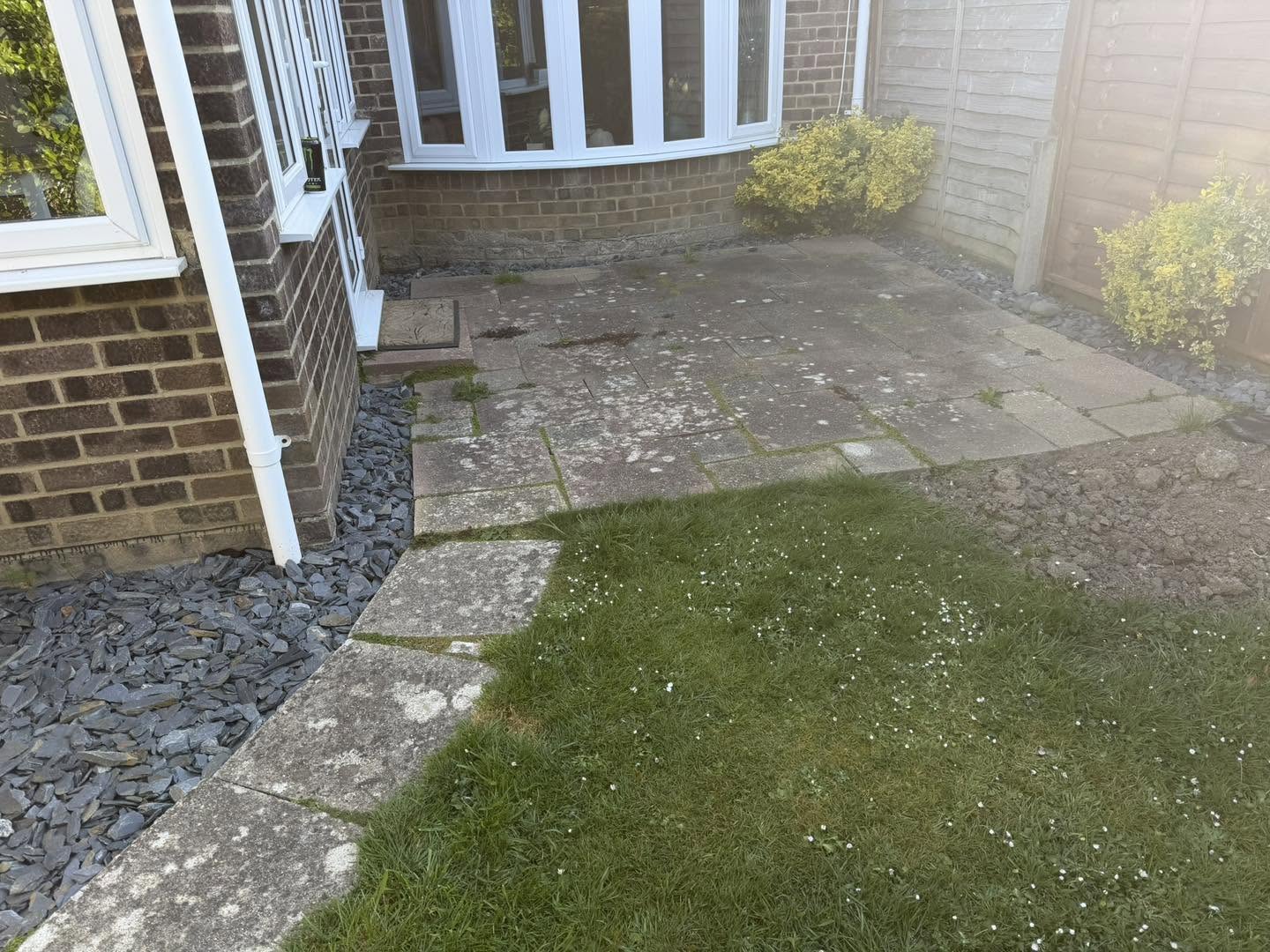 Before: an old worn path and patch of lawn beside the house