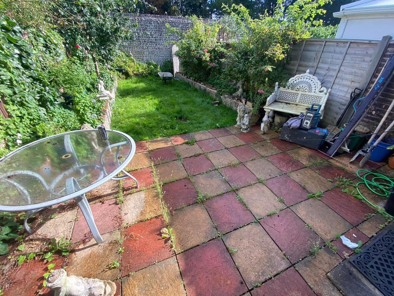 Before: an old red and buff slab patio in Sam Vaughan's garden