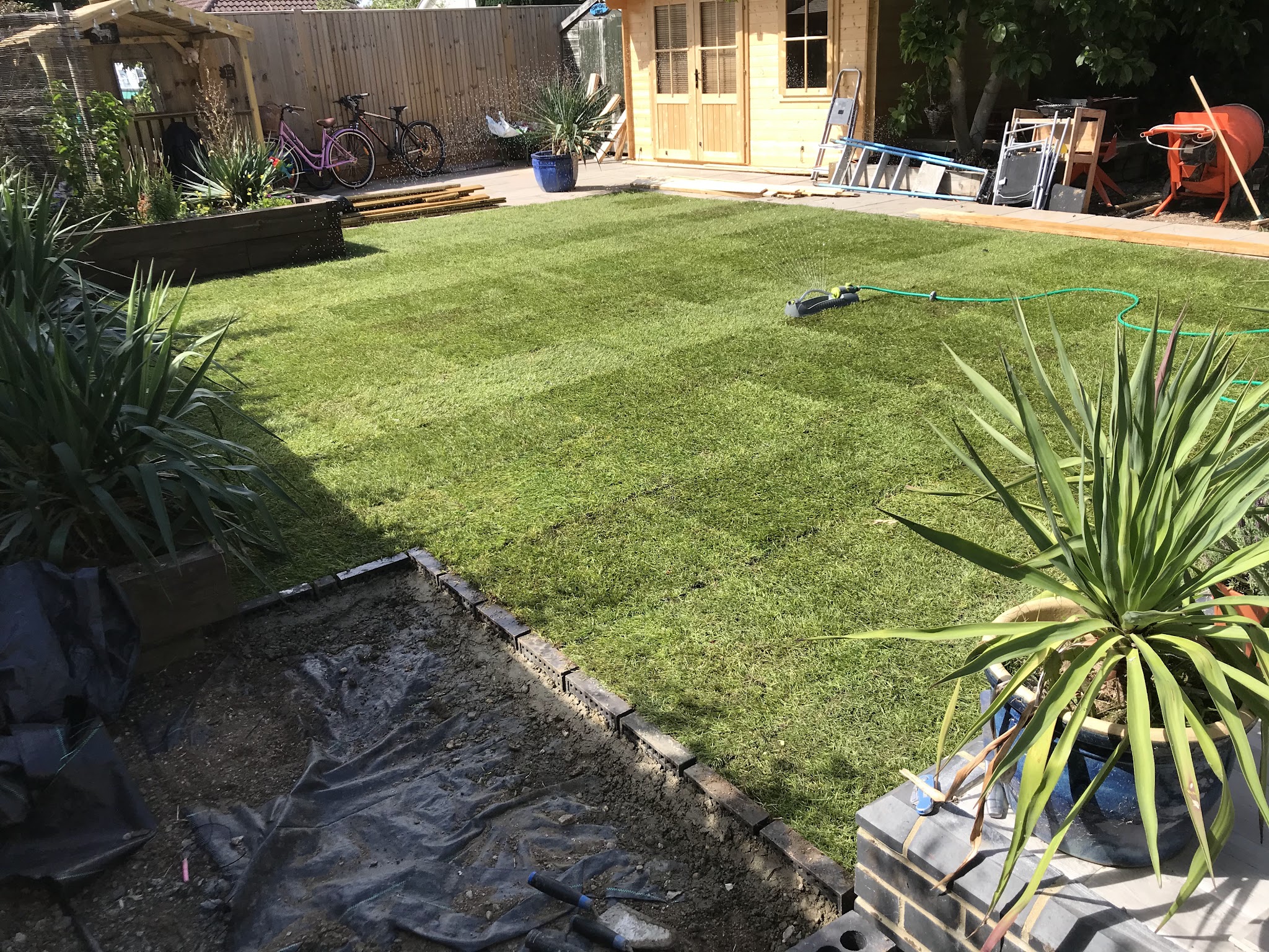 Fresh turf laid with a block edge in a back garden